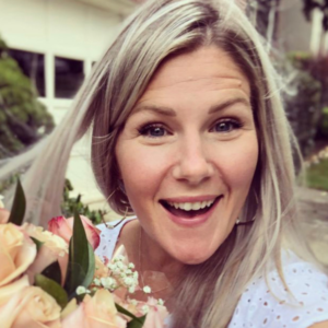 Tara Stack holds a bouquet of flowers