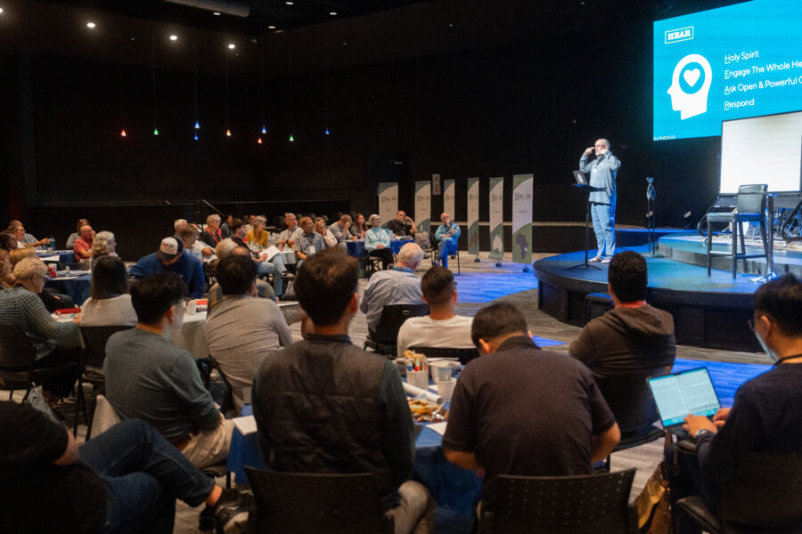 A man presents to a room of ministers for Life on Life Ministries