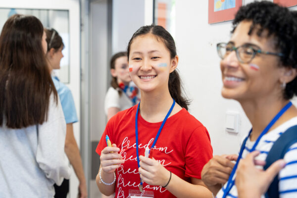 A female GO Journey team member smiles at incoming students in Poland