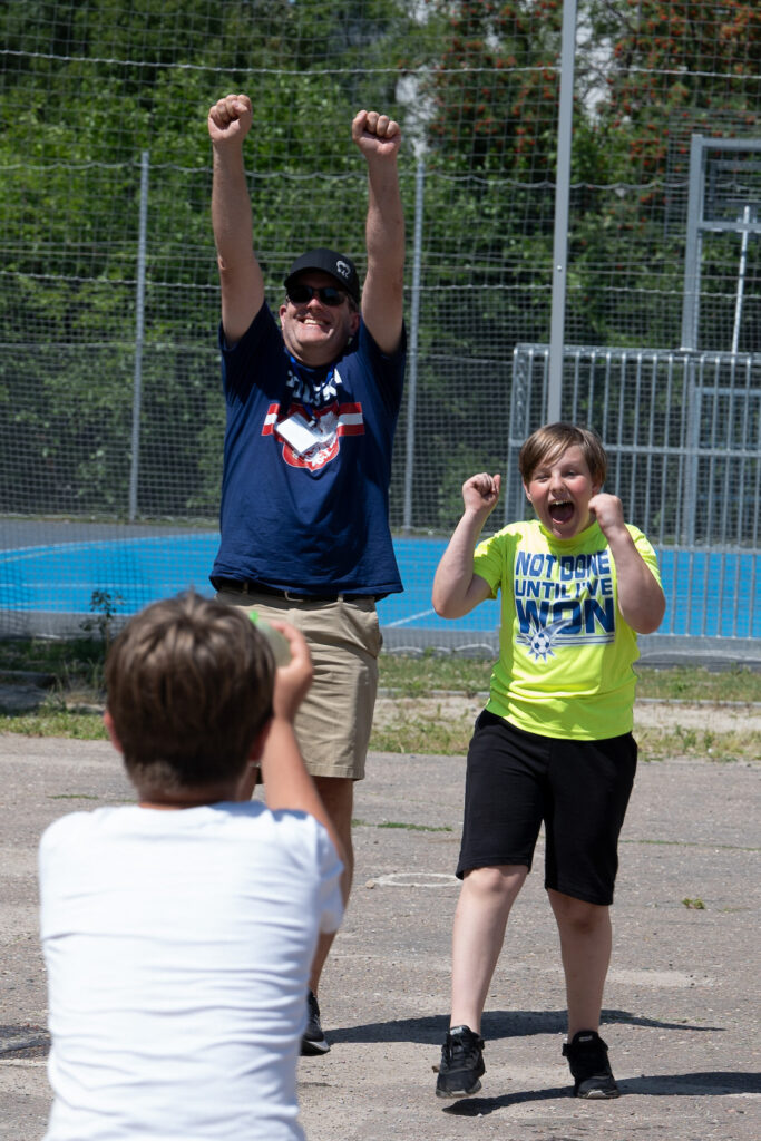A man and a boy celebrate playing sports at a camp for Polish and Ukrainian youth (GO Poland)