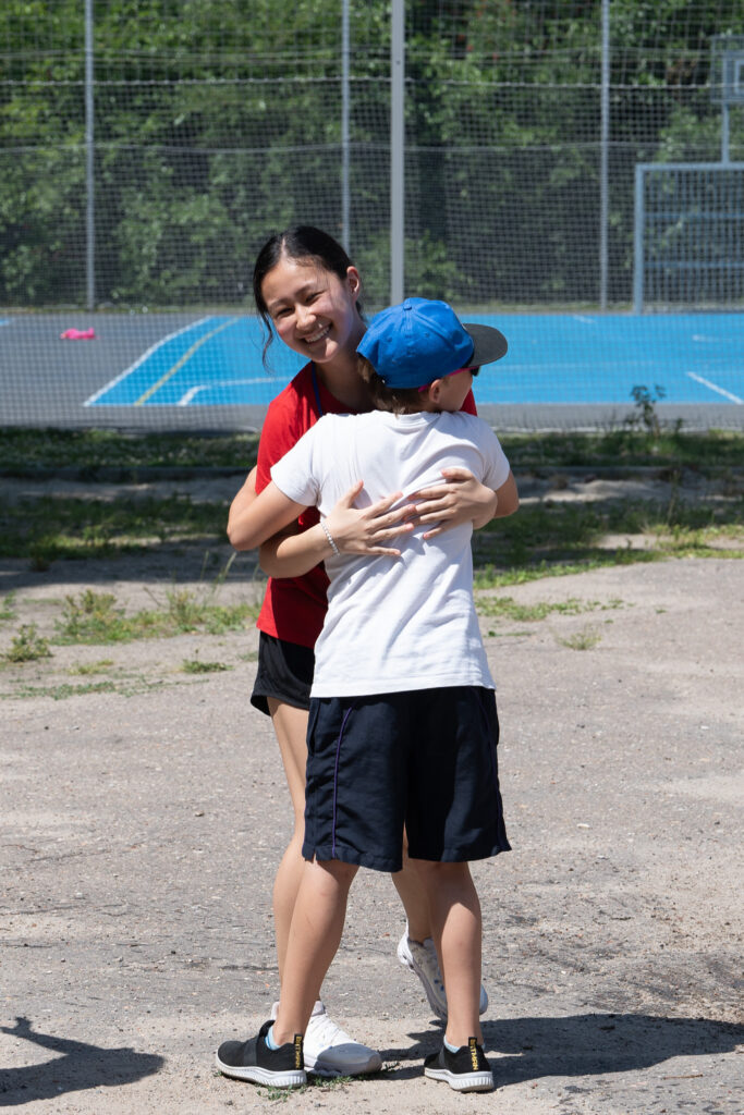 A child hugs a female GO Journey team member in Poland