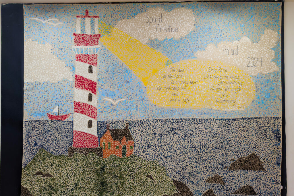 A large wall-sized painting of a lighthouse is displayed at a camp for Polish and Ukrainian youth (GO Poland)