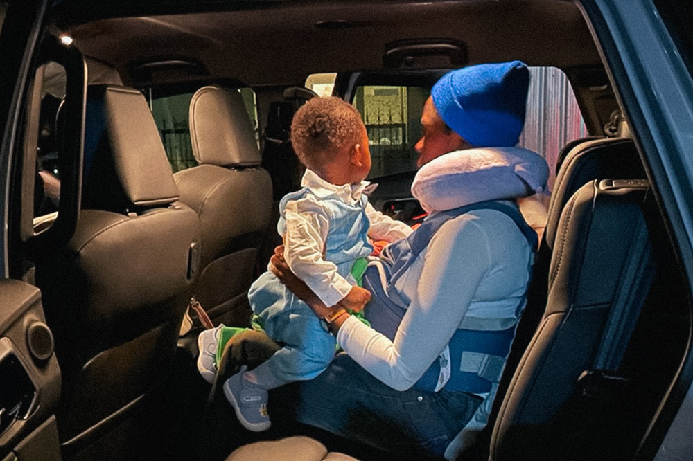 A mother and child arrive in a vehicle