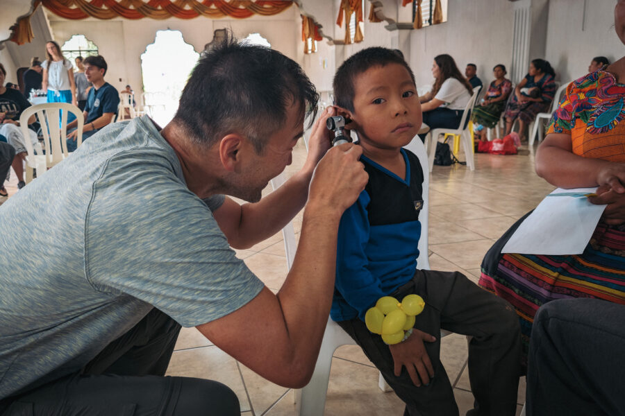 A Medical Missions Ministries practitioner examines a child's ear