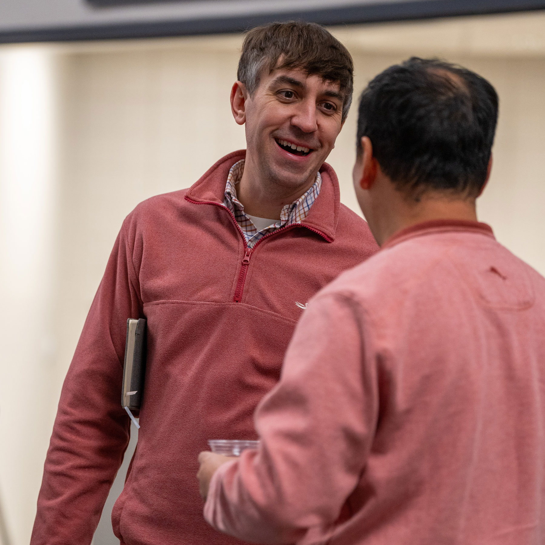 Two men converse with each other in the hallway at Perimeter Church