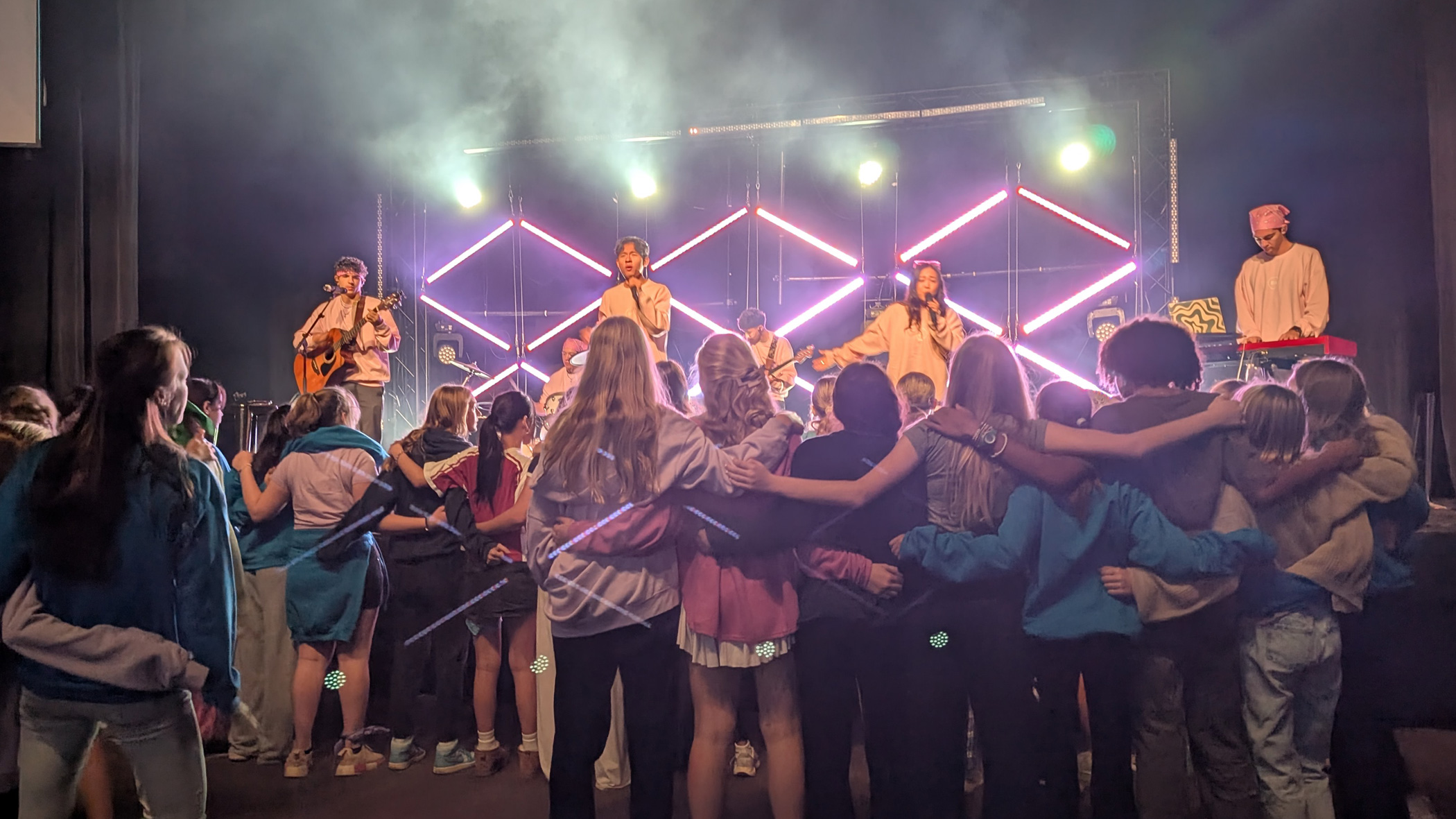 Middle schoolers participate in a worship service at their fall retreat